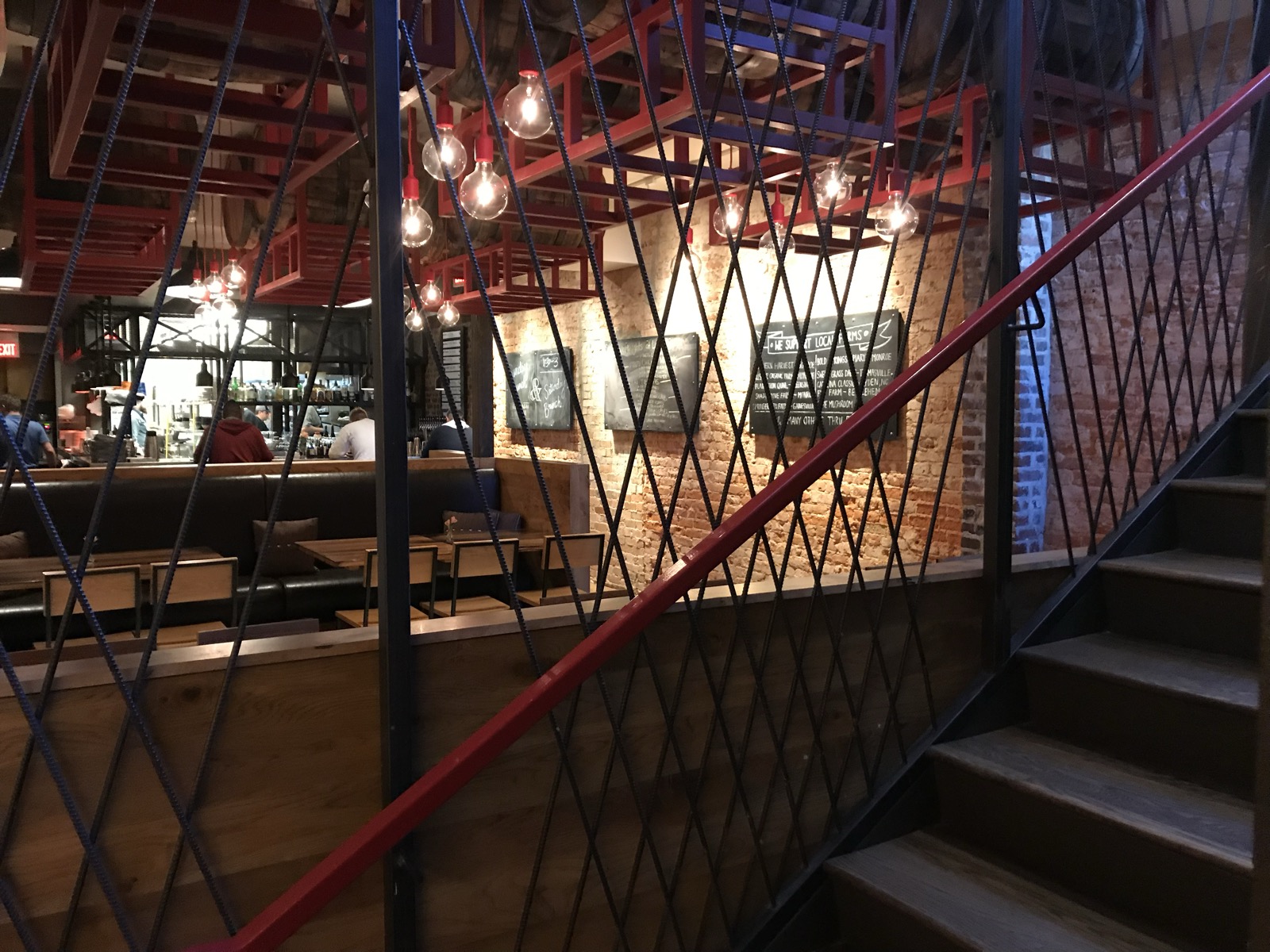 Interior of Local Republic — exposed brick, red-steel staircase, dining