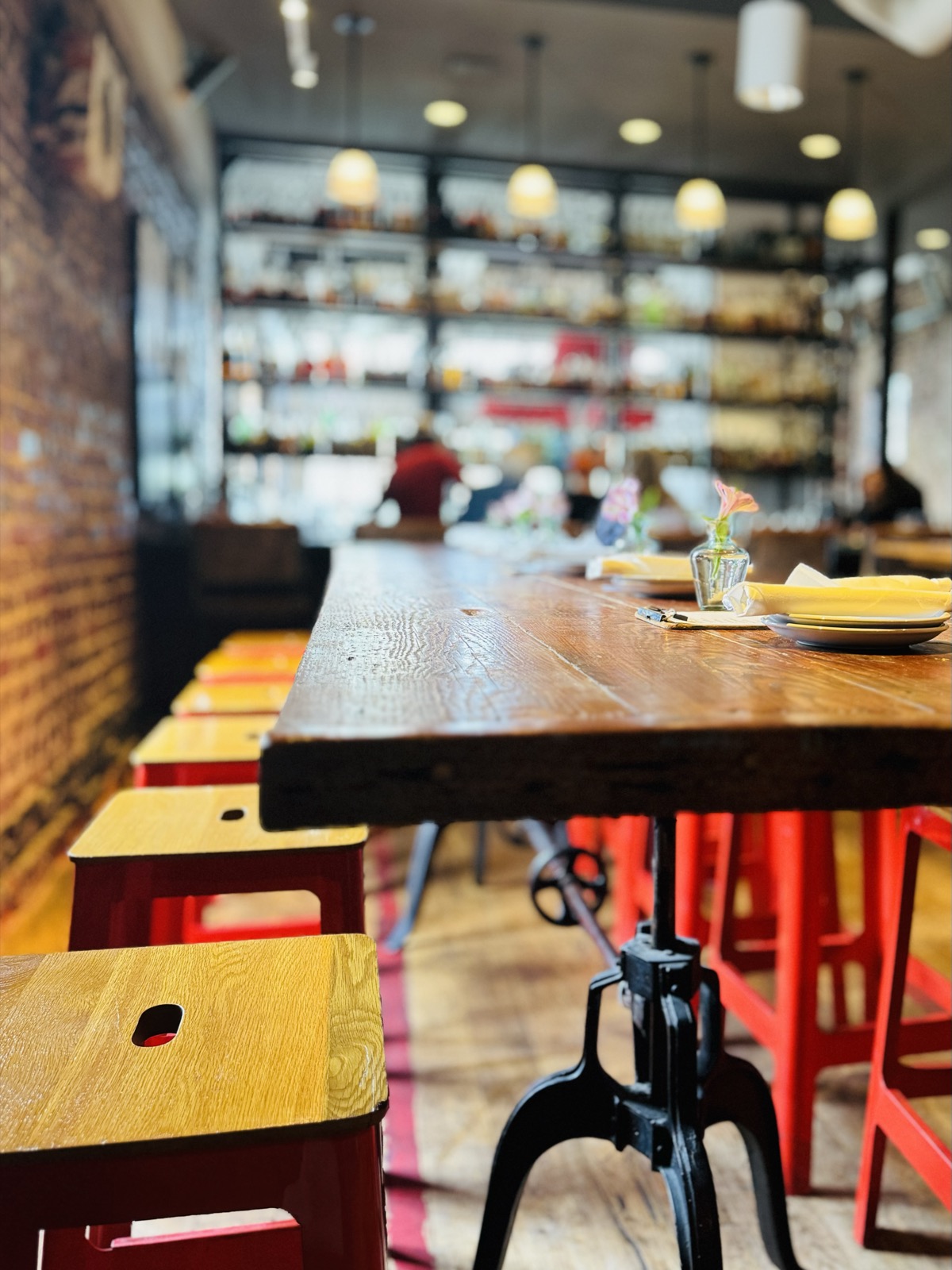 Communal dining table with red industrial stools