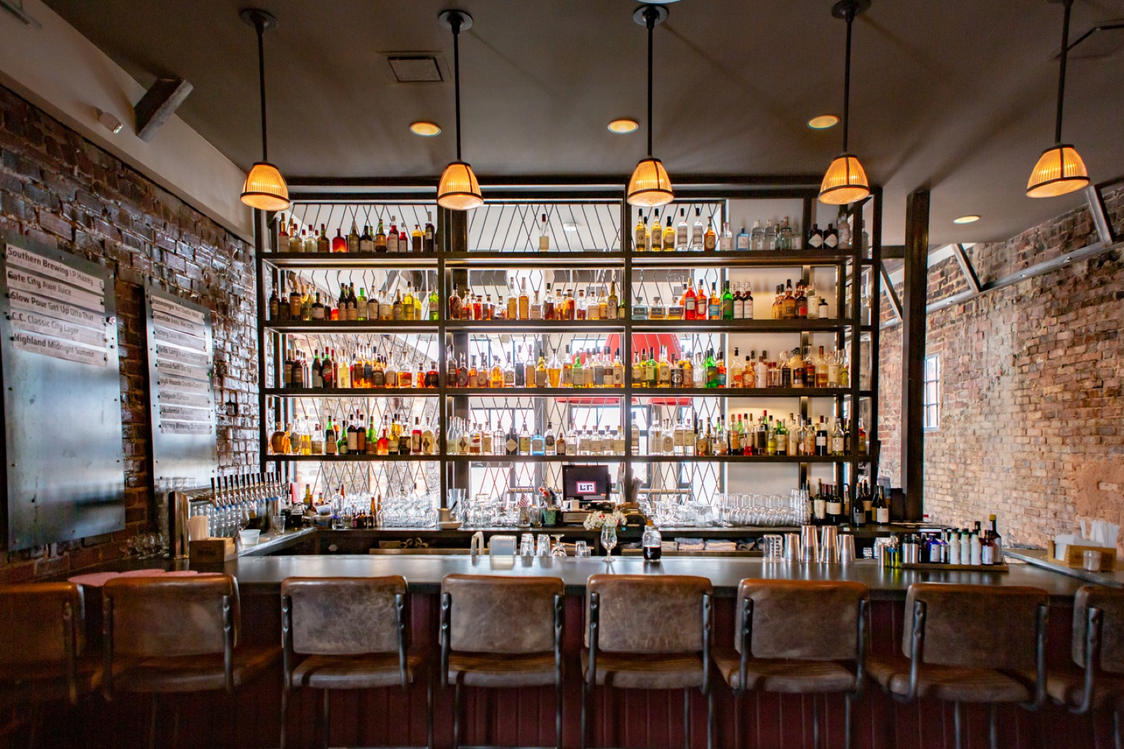 The main bar at Local Republic — full back bar, exposed brick, draft taps