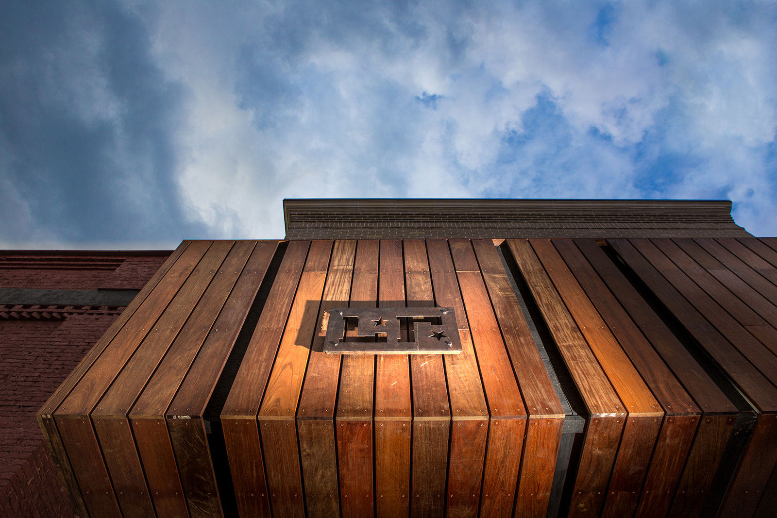 Wood-clad facade with the Local Republic monogram