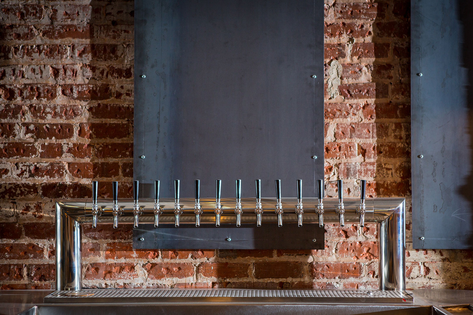 14-tap draft tower against exposed brick